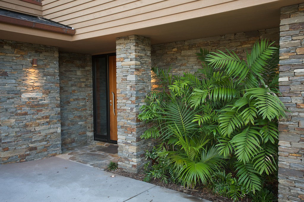 view of front door and plms next to it